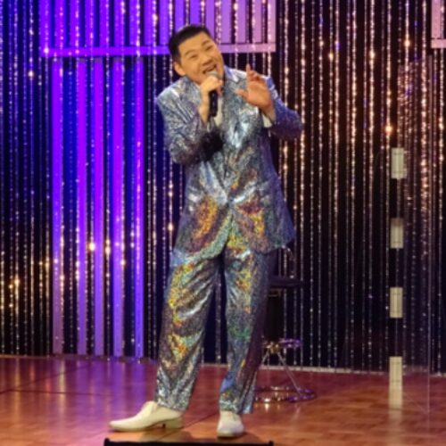 ステージ上で歌っている大江裕